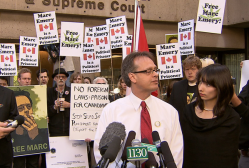 Marc and Jodie Emery speaking to supporters and journalists about Marc's expected 5-year prison term in the United States (Photo from CTV)